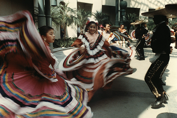 Folklórico dancers perform outside of the California Center of the Arts, Escondido, California. This image was likely taken at the opening ceremony for the Center, 1994. 
